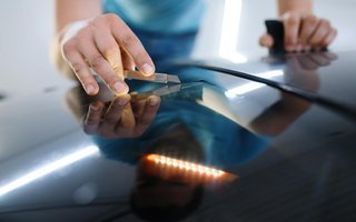 Werkzeug wird an Windschutzscheibe angesetzt.